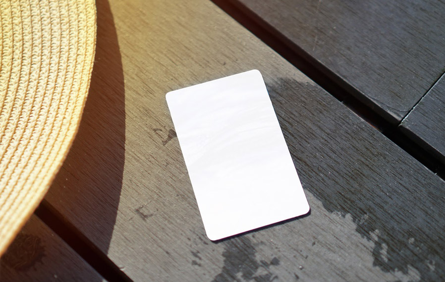 Don't forget your pool pass to to take a refreshing swim at One One Six Apartments. Summer hat and key card on a deck floor.