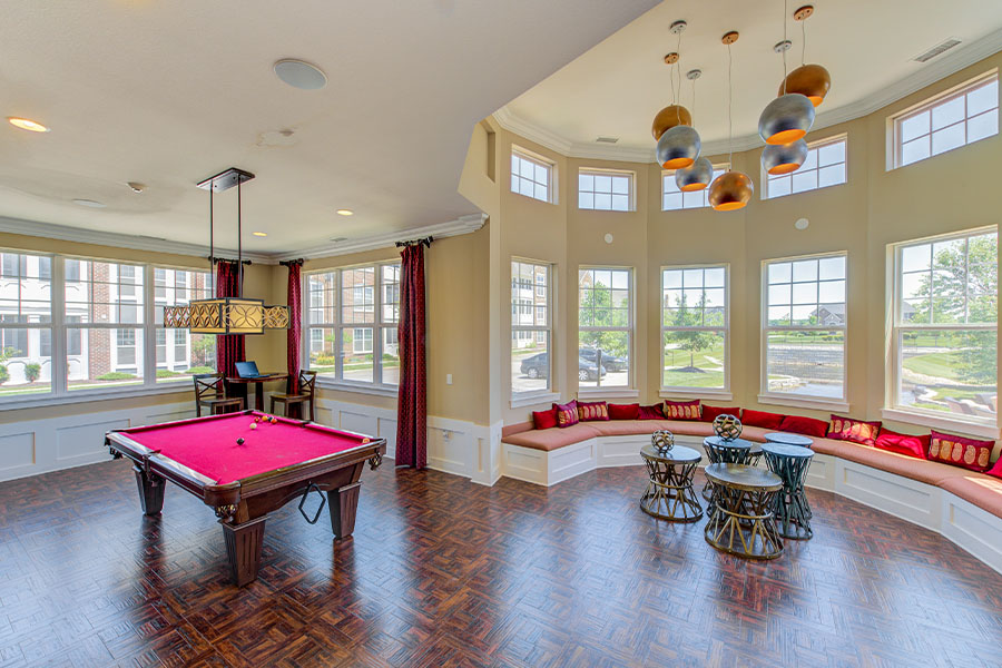 Red and beige recreation room at Hamilton Luxury Apartments.