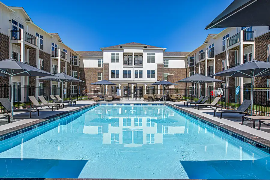 Pristine pool surrounded by apartment buildings at One One Six Apartments Apartments.
